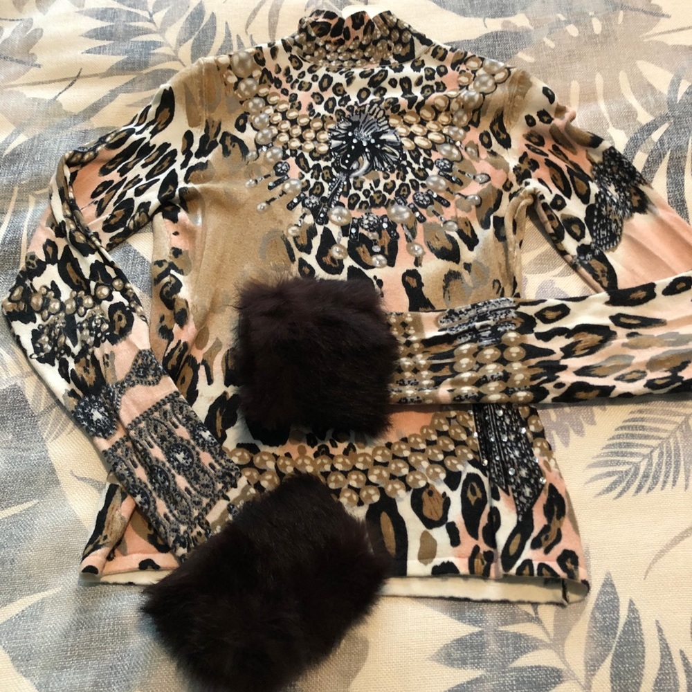 Animal print sweater with faux fur cuffs.